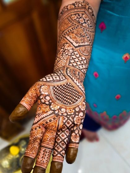 A close-up of a palm filled with intricate details, including checkerboard patterns and floral elements.