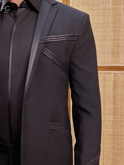 A close-up of the stitched detailing on the suit jacket. This is a subtle yet powerful element that showcases the garment's unique design.