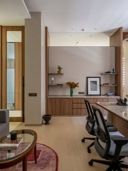 This office blends modern furniture with classic details like wall paneling and traditional art. The result is a timeless and sophisticated space that feels both powerful and comfortable.