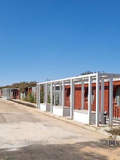 A long shot of the entrance road at Aamby City, showing the series of seating areas.