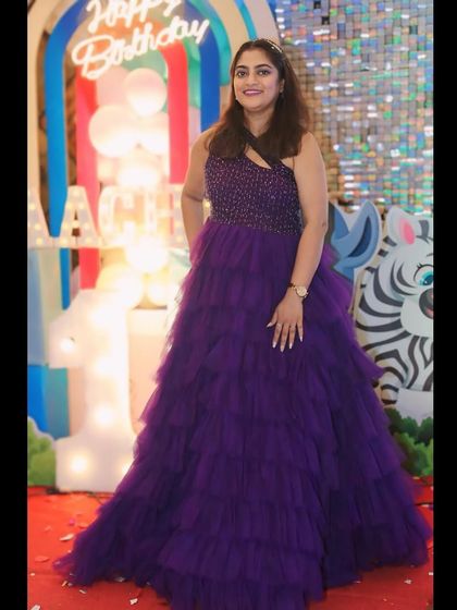 A client celebrating her birthday in my purple layered gown. It's a fun and festive choice that guarantees you'll be the center of attention.