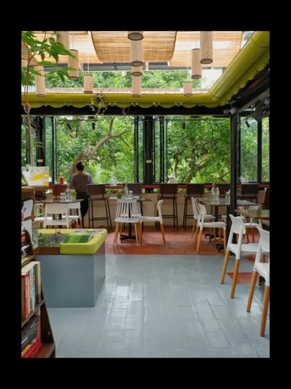 Champaca Bookstore is a sanctuary designed for quiet contemplation. We used simple plywood and custom bamboo lighting, but the main feature is the large window, which frames the lush outdoor greenery and brings a sense of natural calm into the reading space.