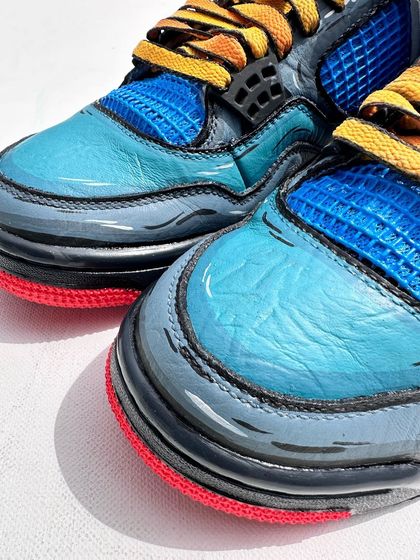 A toe-box view of the sketchy Dragon Ball Z custom Jordans. The bold black lines give it that classic 2D animation feel, making the colors look even more vibrant.