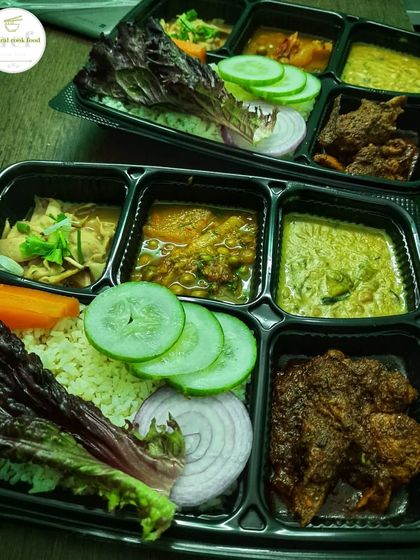 An evening snapshot of my chicken thalis, packed with fresh vegetables and a variety of curries.