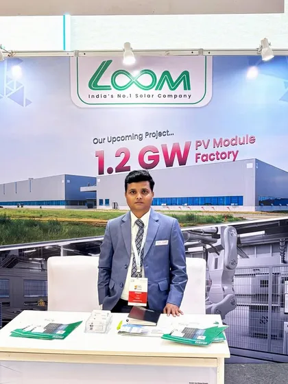Our representative at the Gujarat expo, standing proud before a backdrop showcasing our massive upcoming PV Module Factory, a key part of our growth strategy.