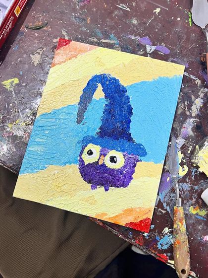 A whimsical owl wearing a wizard's hat, created with thick, playful strokes of paint. This shows how versatile and fun impasto painting can be for all ages.