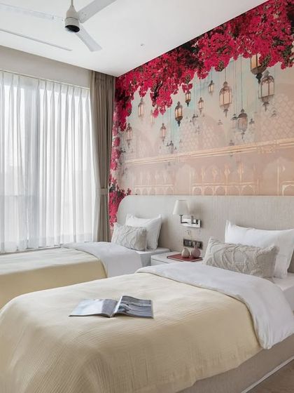 A beautiful bedroom for two, featuring a stunning floral and architectural wallpaper. We kept the bedding and headboards neutral to let the vibrant wallpaper be the star of the room.