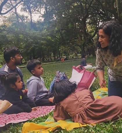 A wider perspective of our story circle, showing how we fit into the larger, vibrant atmosphere of Cubbon Park on a Saturday.
