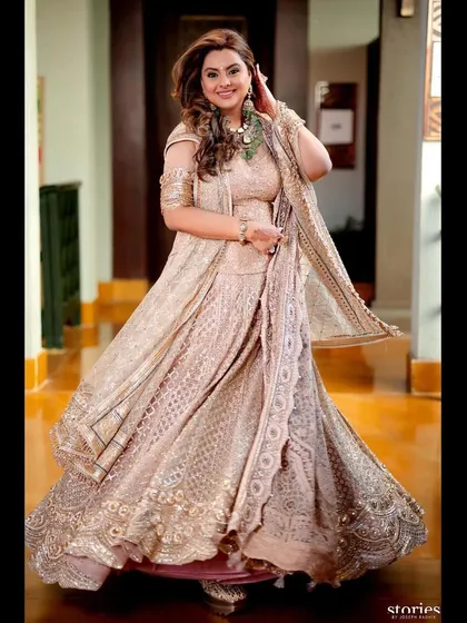A full-length view of Deepshikha Deshmukh's wedding guest look. The hair was designed to have movement and bounce, perfectly matching the flow of her gorgeous lehenga.