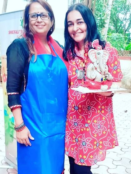 A happy student poses with me and her beautifully crafted eco-friendly Ganesha, a wonderful result of our hands-on workshop.