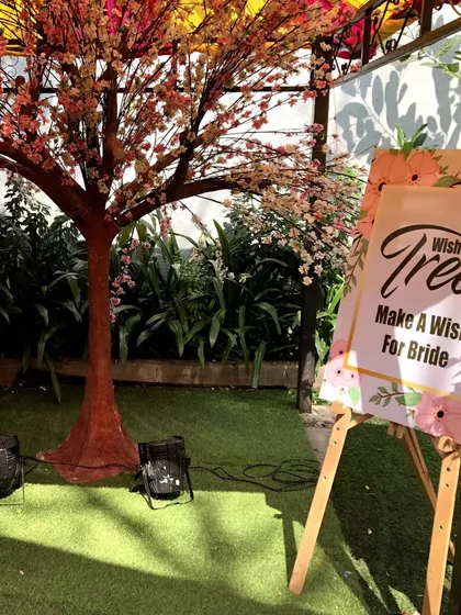 The 'Wish Tree' is a wonderful way for guests to share their blessings. Here, guests can write a wish for the bride and hang it on the tree, creating a beautiful and interactive keepsake.