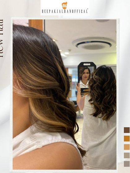 Sun-kissed curls perfect for summer. The highlights are strategically placed to mimic where the sun would lighten the hair, creating a beautiful money piece effect.