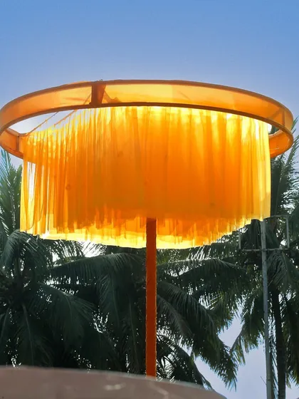 A custom-made lampshade with bright yellow tassels, adding a touch of whimsy and tying into the vibrant color scheme of the 'Love in Mexico' theme.