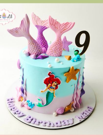 Making a splash with this delightful mermaid cake for a 9th birthday. The design features shimmering mermaid tails, an Ariel figure, and other under-the-sea details in a beautiful aquatic color palette.
