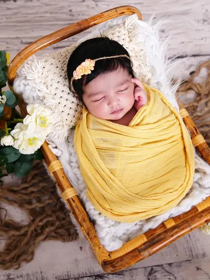 A sweet newborn wrapped in a yellow swaddle, sleeping peacefully in a basket. These simple, natural shots are timeless.