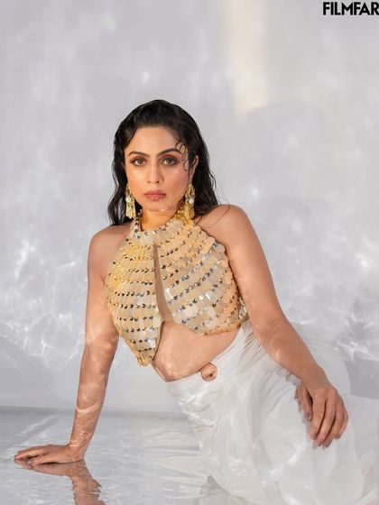 A seated portrait from the Filmfare shoot, focusing on a more intimate and composed mood. The interplay of light and shadow on the water creates a serene yet captivating effect.