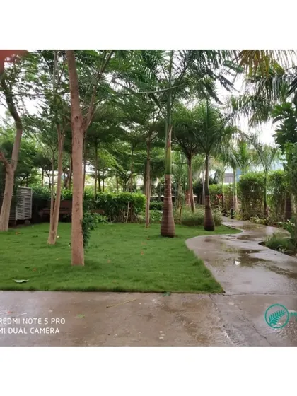 A winding path through another section of a large garden project. Our team ensures that pathways are kept clear and the surrounding lawn and trees are perfectly manicured, inviting people to walk through and enjoy the space.