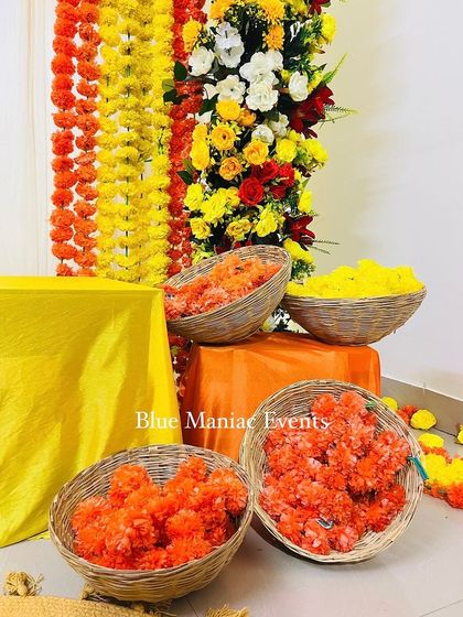 A detail shot of the flower baskets filled with orange and yellow marigolds, ready for the ceremony.