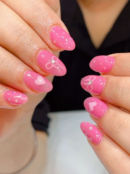 A super cute and girly design with a bright pink base, adorned with tiny white hearts, bows, and polka dots.