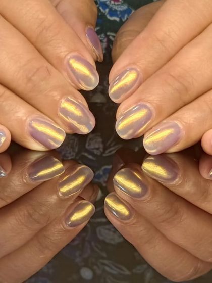 A unique cat-eye design with a golden shimmer over a light purple base, creating a magical, iridescent look.