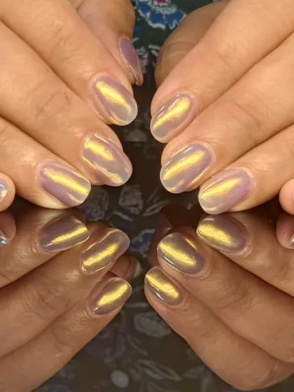 A unique cat-eye design with a golden shimmer over a light purple base, creating a magical, iridescent look.