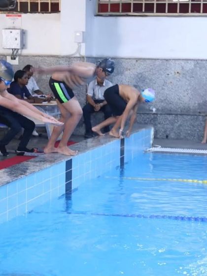 Young swimmers get ready to dive into the pool at the start of a race during our 'Nautica' aquatic meet. Our coaches provide expert guidance on techniques like proper diving starts to give our athletes a competitive edge.