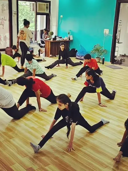 Students in a Jazz class work on floor exercises and stretches. A strong foundation in flexibility and strength is essential for any dance form.