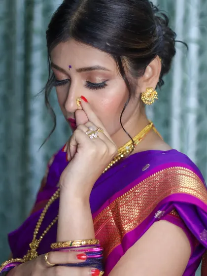A close-up showcasing the intricate details of the eye makeup and the traditional Marathi nath.
