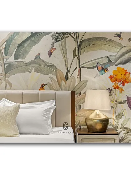 A close-up of a bedroom where a lush, tropical wallpaper creates a vibrant backdrop. The brass lamp and soft, neutral bedding provide a perfect balance, making the room feel like a stylish, exotic retreat.