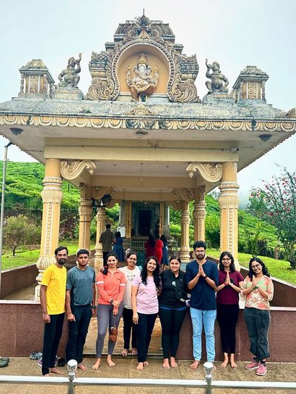 The group visiting a beautiful temple set amidst a tea estate, a perfect blend of culture and nature.