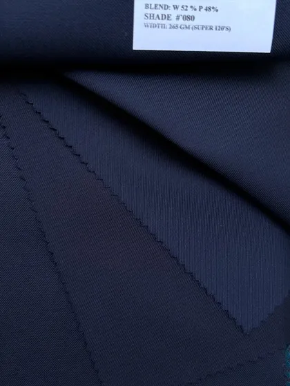 A swatch of a wool-polyester blend, a durable and versatile option for everyday suits. The label shows the composition, width, and weight, information we share for every fabric.