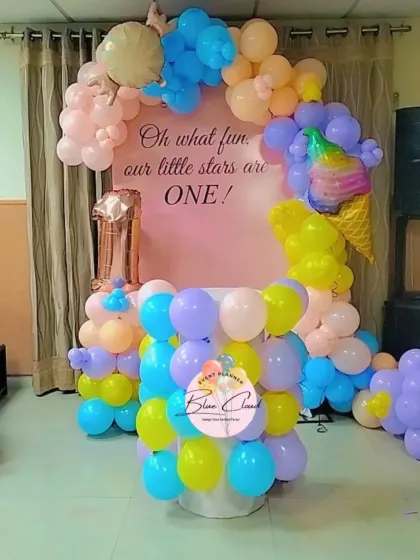 An "Oh what fun" ice cream and stars themed party for a first birthday. We used pastel balloons and an ice cream cone foil balloon to create this sweet setup.