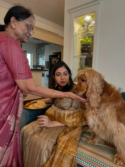 Grandma feeding Posto a little treat during the baby shower. He gets pampered by everyone.