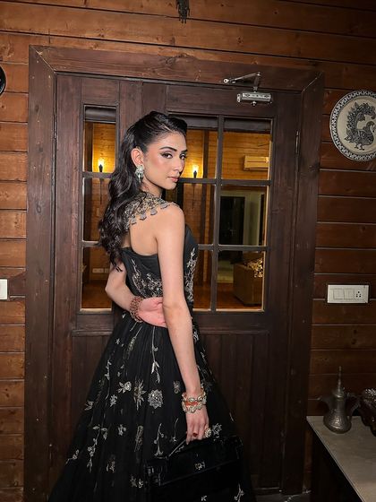 A beautiful shot from the back, showing the elegant hairstyle and the way the makeup enhances her profile. Every detail is considered to create a complete and cohesive look.