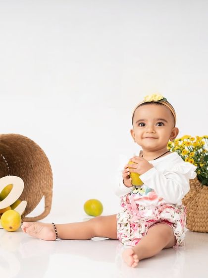 Another shot from the mango madness session. The simple white background and natural props keep the focus on the baby and the vibrant colors of the fruit.