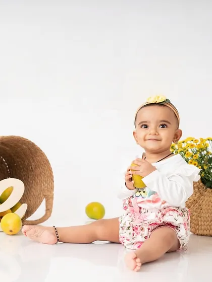 Another shot from the mango madness session. The simple white background and natural props keep the focus on the baby and the vibrant colors of the fruit.