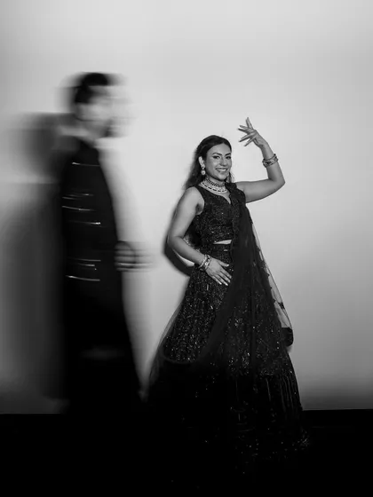 A black and white artistic shot capturing the bride's dance move, full of grace and energy.