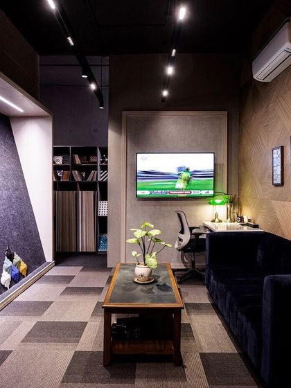 For this tile sampling area at La Casa Decor, a wall grazer fixture was installed. This technique casts light down the wall at a sharp angle, revealing the subtle textures and finishes of the tile samples, which is critical for client decision making.