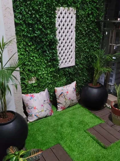 This is the seating area of the child's balcony. I placed some comfortable floor cushions on the artificial grass, creating a perfect spot for reading stories or just relaxing against the green wall.