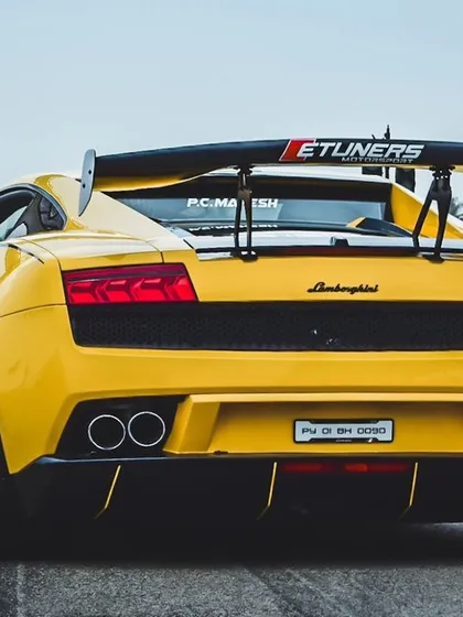 The rear view of the yellow Lamborghini Gallardo, showcasing its aggressive aerodynamics and dual exhausts. Every detail is built for speed, and our track is the perfect place to unleash it.