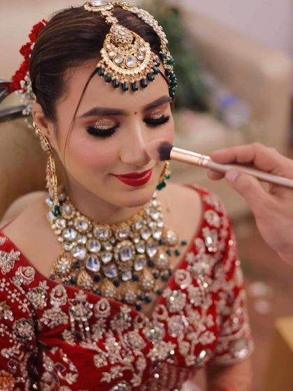 Applying a soft blush to give the bride a natural, healthy flush. It is all about those little details.