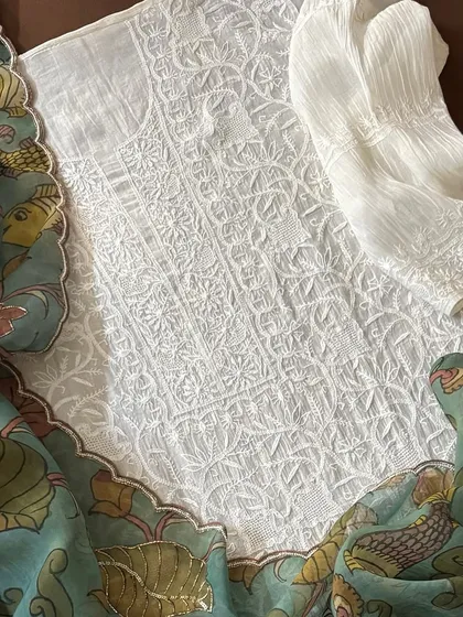 A detail shot of the Chikankari kurta fabric, showing its dense jaal work, paired with the Kalamkari dupatta.