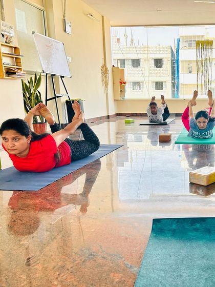 A different angle of the class in Dhanurasana (Bow Pose). Notice the concentration and effort from each student as they work on this powerful back-opening asana.