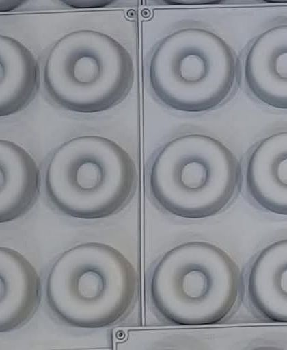 A multi-cavity silicone mold for making small donut-shaped soaps or wax melts. The uniform design is great for producing consistent batches.