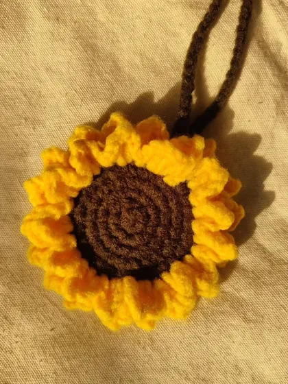 This sunflower charm is a great way to personalize your belongings. It's handcrafted with care and designed to be a durable and beautiful accessory.
