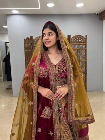 A close-up shot focusing on the beautiful dupatta and blouse of the multi-toned velvet lehenga. The craftsmanship is evident in the detailed embroidery.