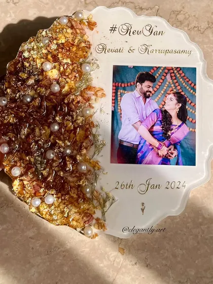 This frame is a perfect example of a half-flower, half-photo design. The preserved varmala flowers and pearls are on one side, leaving the other side clear for the photo and personalized text.