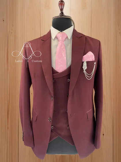 Another look at the maroon suit, this time paired with a pink tie and pocket square. It shows the versatility of the color and the importance of custom styling.