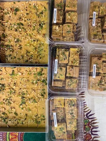 Large trays and packed boxes of my signature Mohanthal. I prepare this festive sweet in bulk for large orders and celebrations.