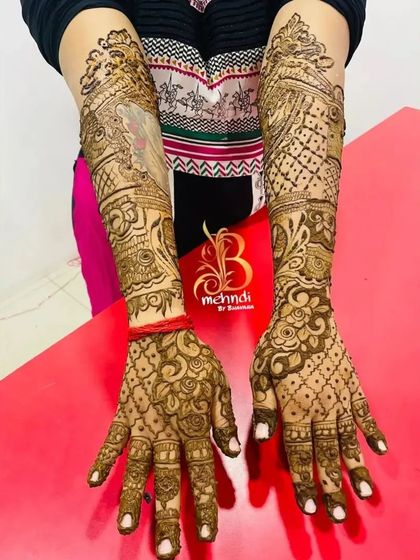 Another view of the full-arm henna with the custom pet portrait. This angle shows how the entire design flows together from the hands to the elbows.